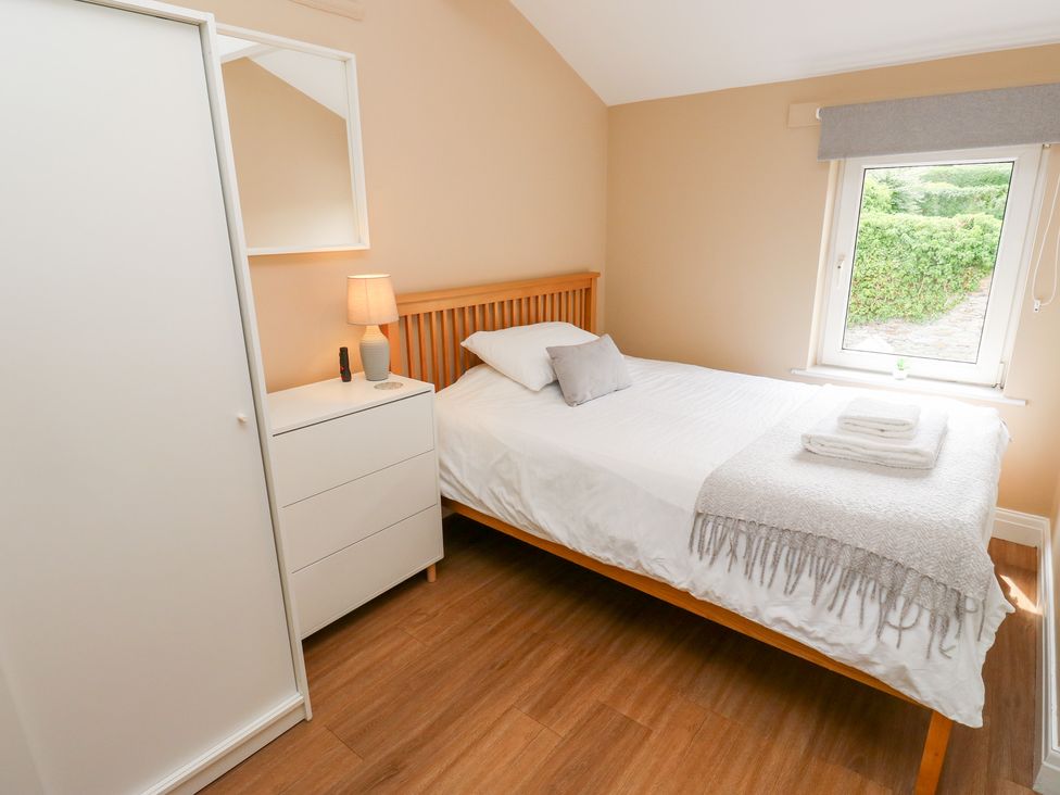 A bedroom with a bed and bedside lamp at Farnhill View in Cross Hills