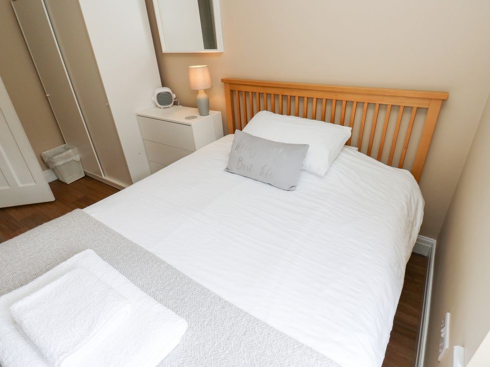 A bedroom with a bed and lamp at Farnhill View in Cross Hills