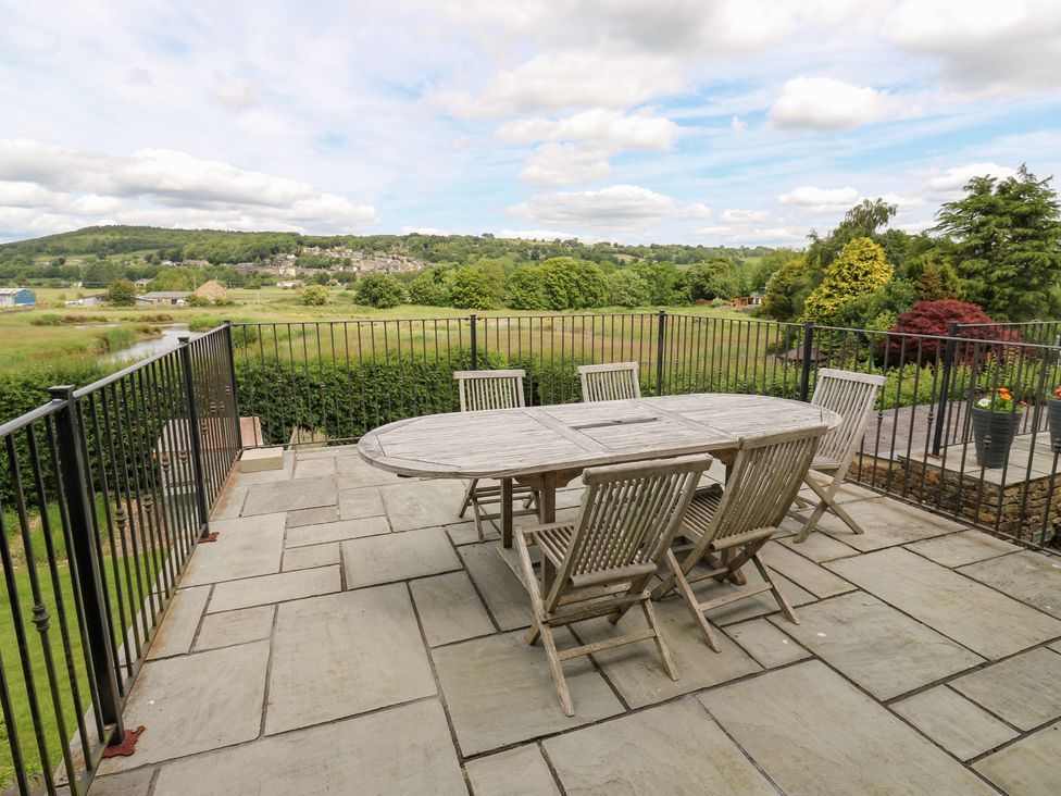 An outdoor dining area with a table and chairs at Farnhill View in Cross Hills