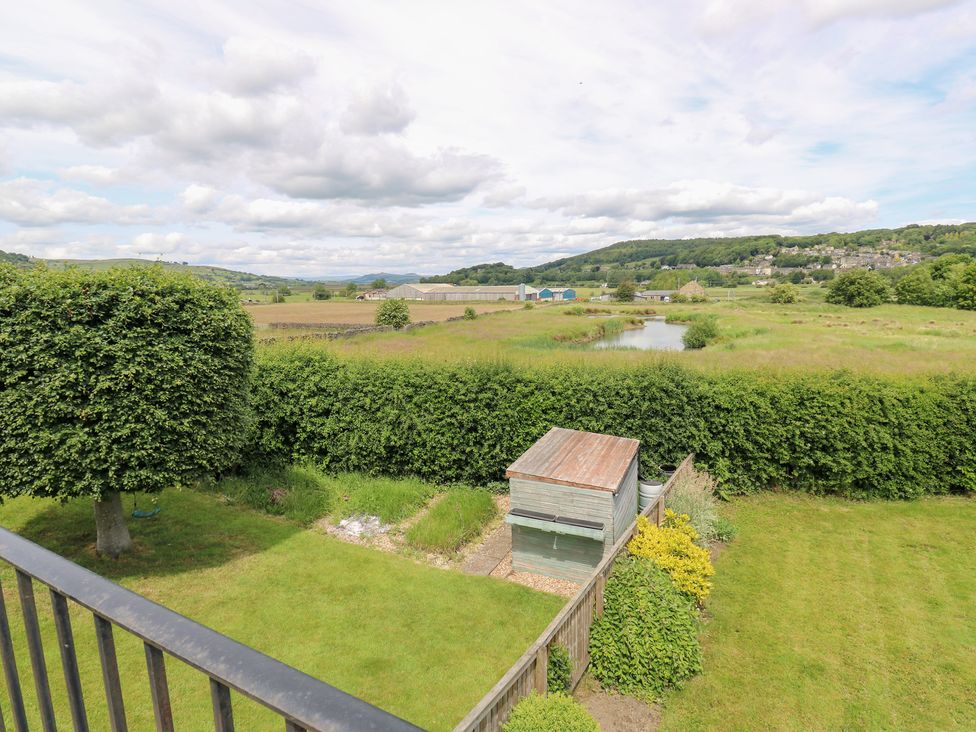 A view of a garden with a shed and a tree at Farnhill View Cross Hills