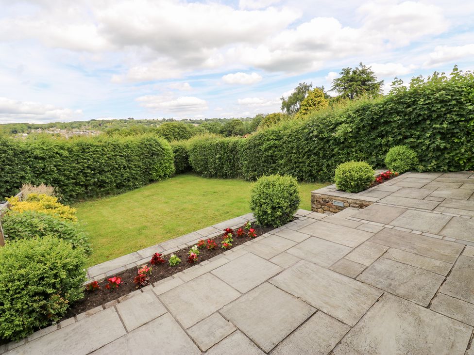 A garden with grass and flower beds at Farnhill View in Cross Hills