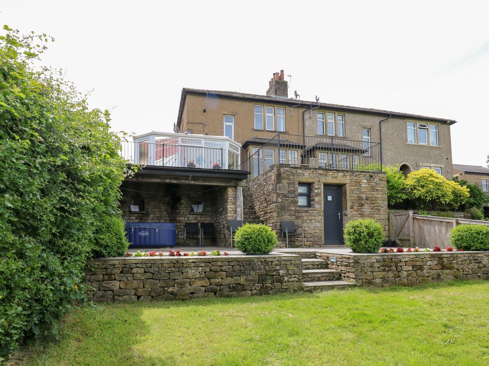 A house with a deck and garden at Farnhill View in Cross Hills