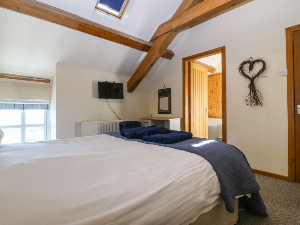 A bedroom with a bed and television at Cefnbron in Llanaelhaearn near Trefor