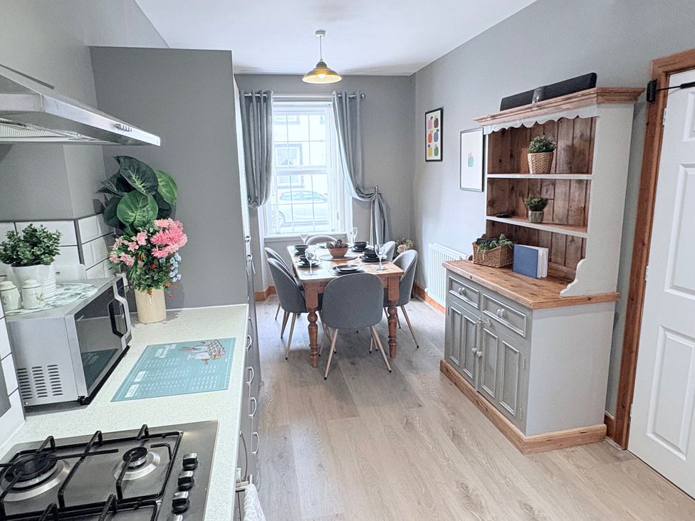 A kitchen with a dining table and chairs at The Oaks Cottage in Penrith