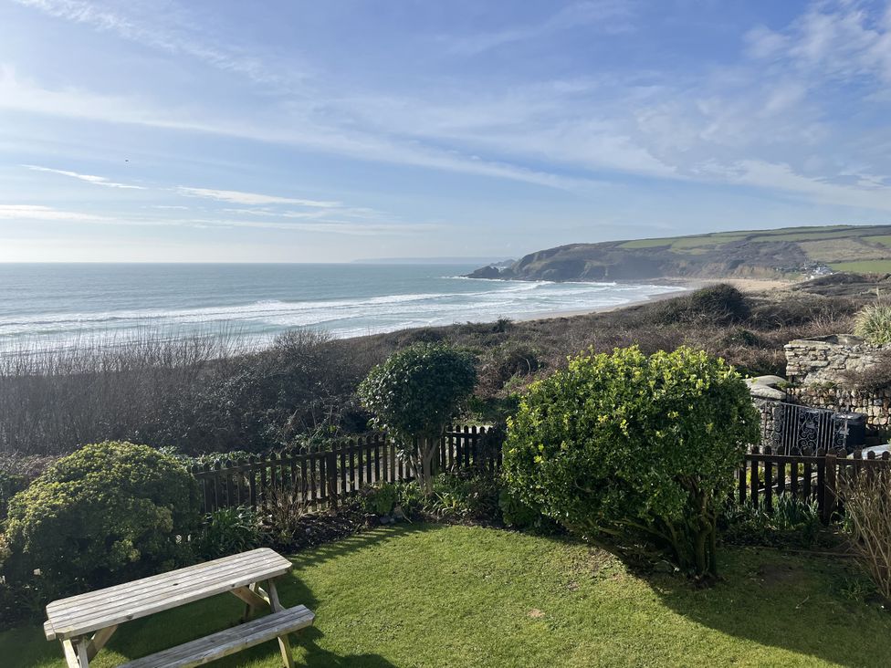 An outdoor view of the ocean and hillside at Stonecroft in Praa Sands