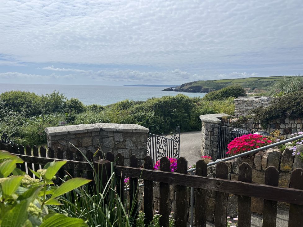 A view of the sea and coastline with a gate at Stonecroft in Praa Sands