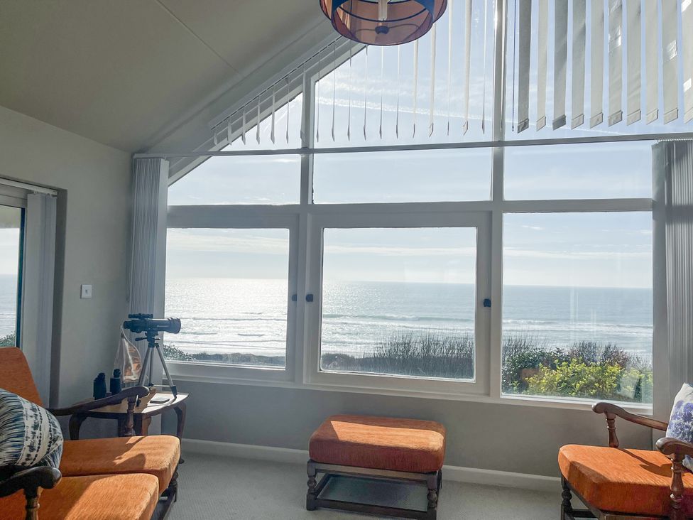 A living room with a view of the ocean at Stonecroft in Praa Sands