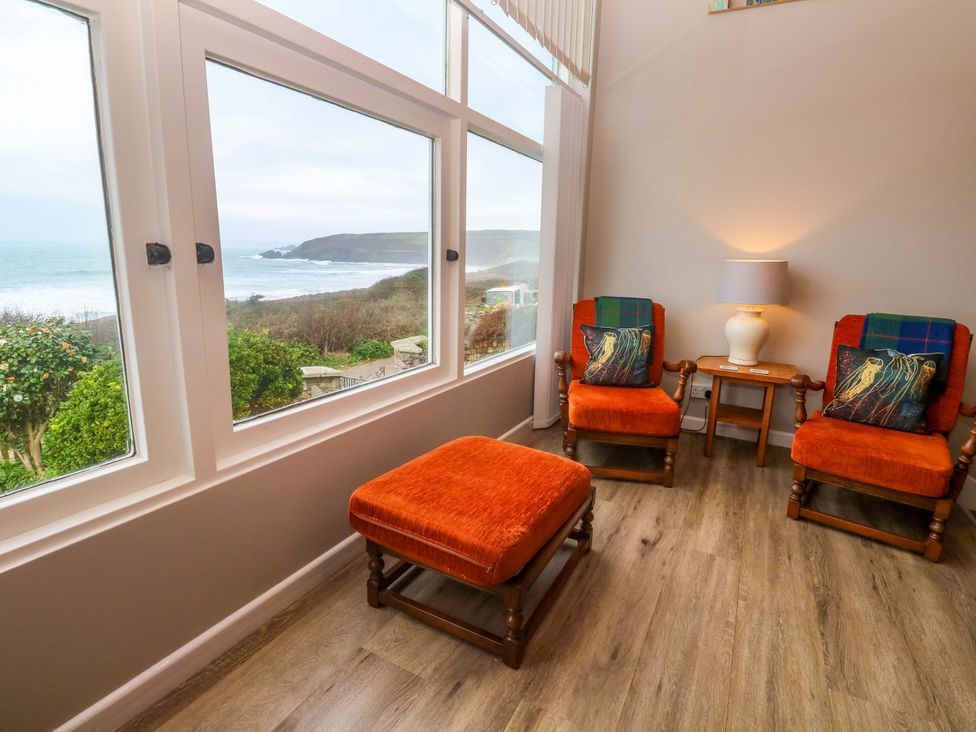 A sitting room with chairs and a lamp at Stonecroft in Praa Sands
