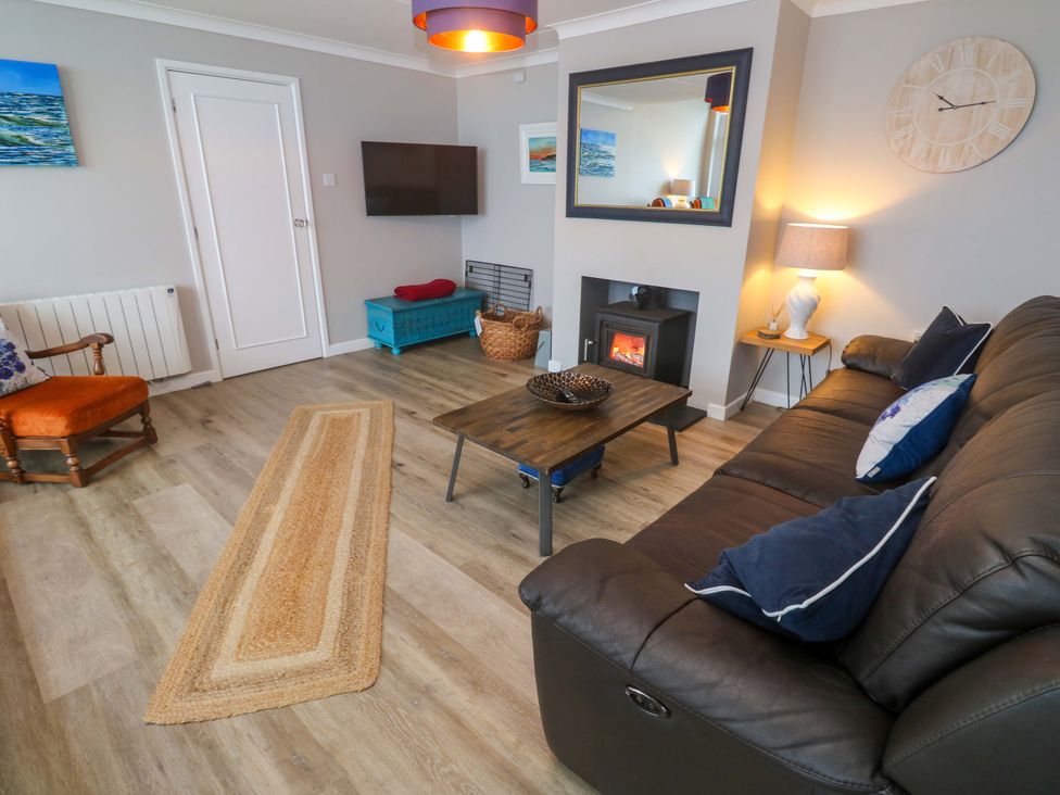 A living room with a sofa and coffee table at Stonecroft in Praa Sands