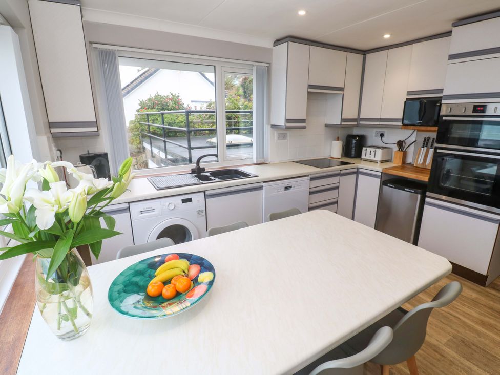 A kitchen with a table and sink at Stonecroft in Praa Sands