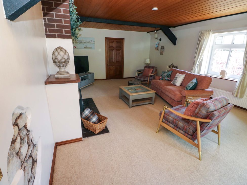 A living room with a sofa and coffee table at The Stables in St Athan