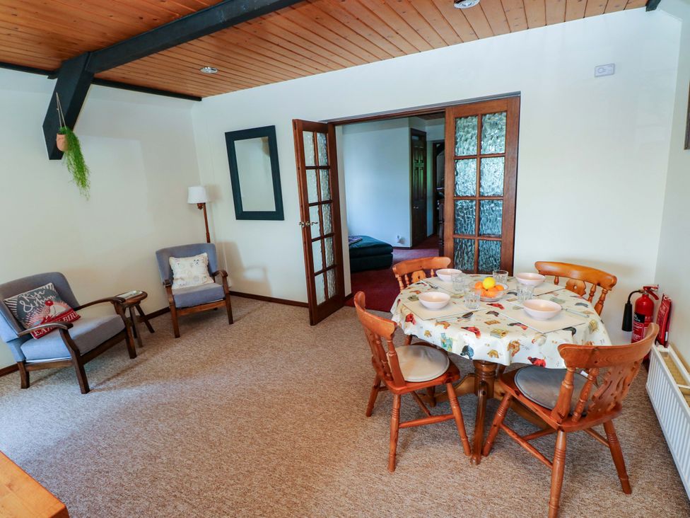 A dining room with a table and chairs at The Stables in St Athan