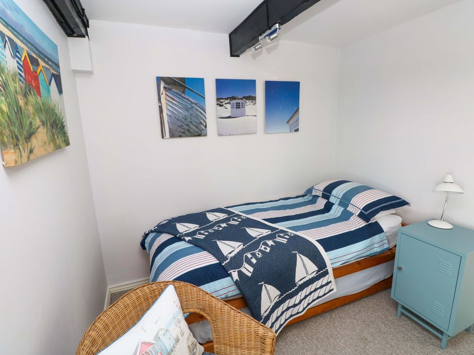 A bedroom with a bed and wall art at The Stables in St Athan