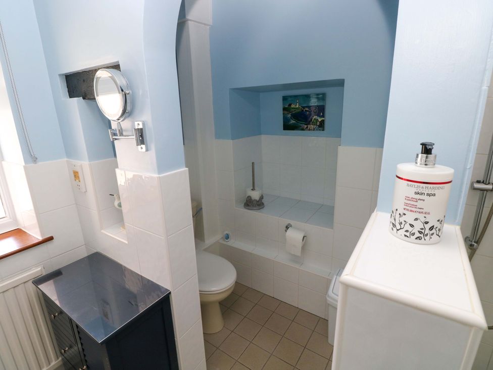 A bathroom with a toilet and sink at The Stables in St Athan