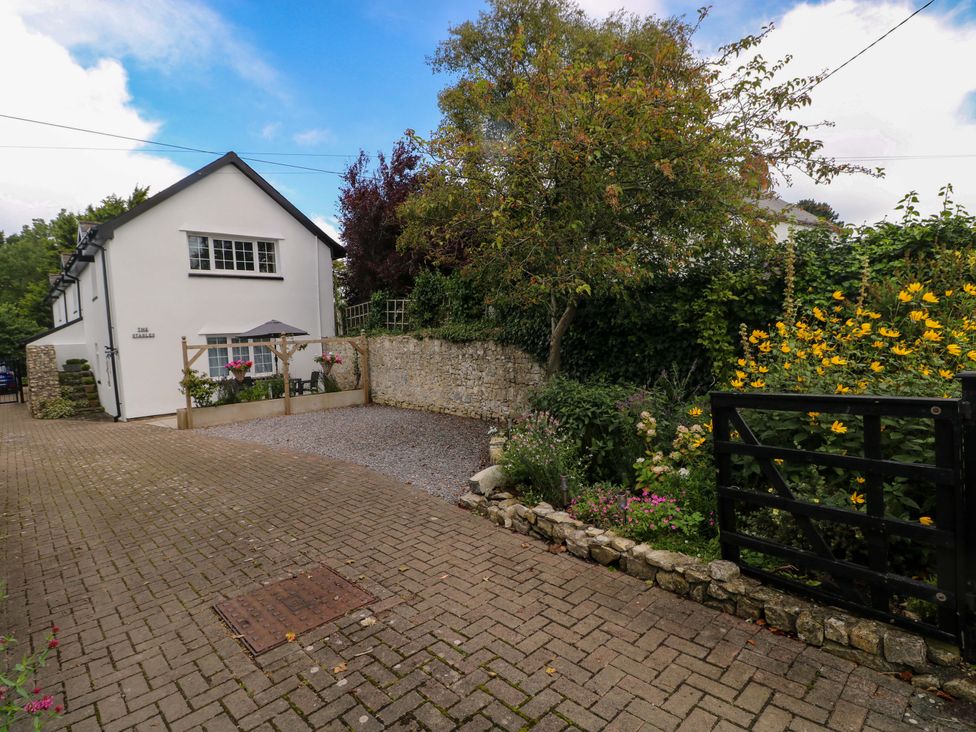 An outdoor view of a house with a pathway and garden at The Stables in St Athan