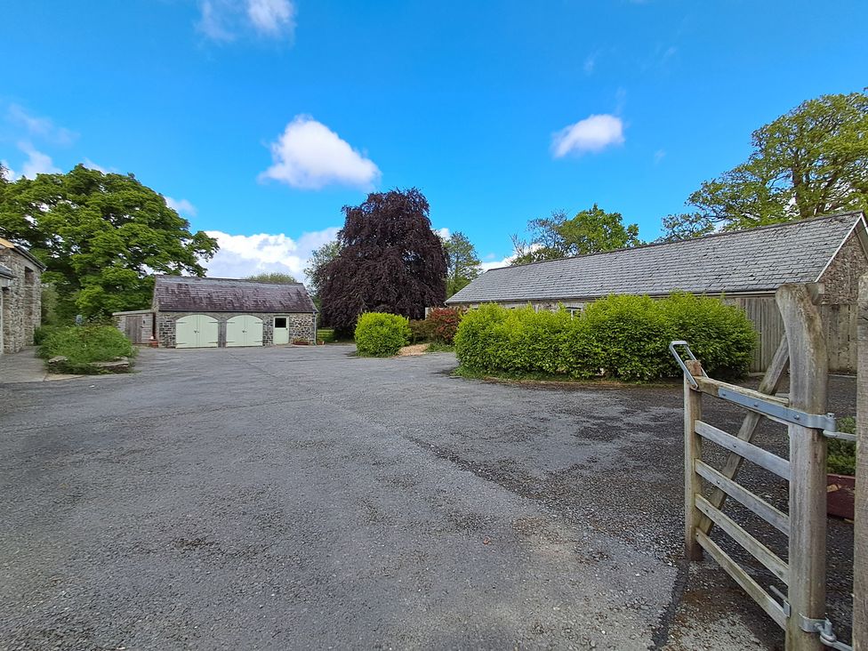 An outdoor area with a garage and shed at Carreg Cennen Cottage Llandeilo
