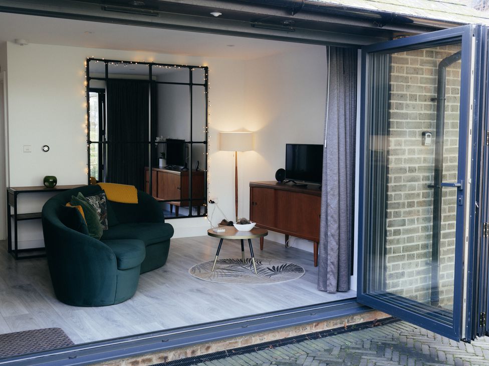 A living room with a sofa and television at The Observatory Annexe Westcott near Dorking