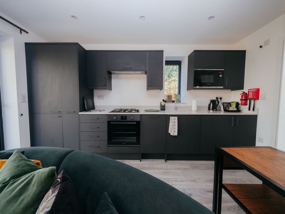A kitchen with modern appliances and storage at The Observatory Annexe Westcott near Dorking