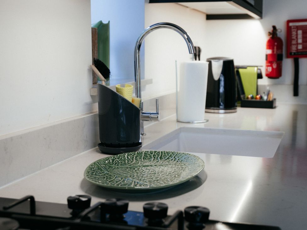 A kitchen with a sink and various utensils at The Observatory Annexe Westcott near Dorking