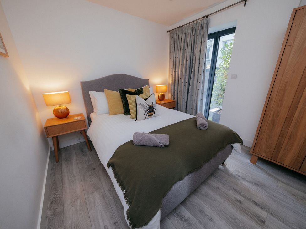 A bedroom with a bed and nightstand at The Observatory Annexe Westcott near Dorking