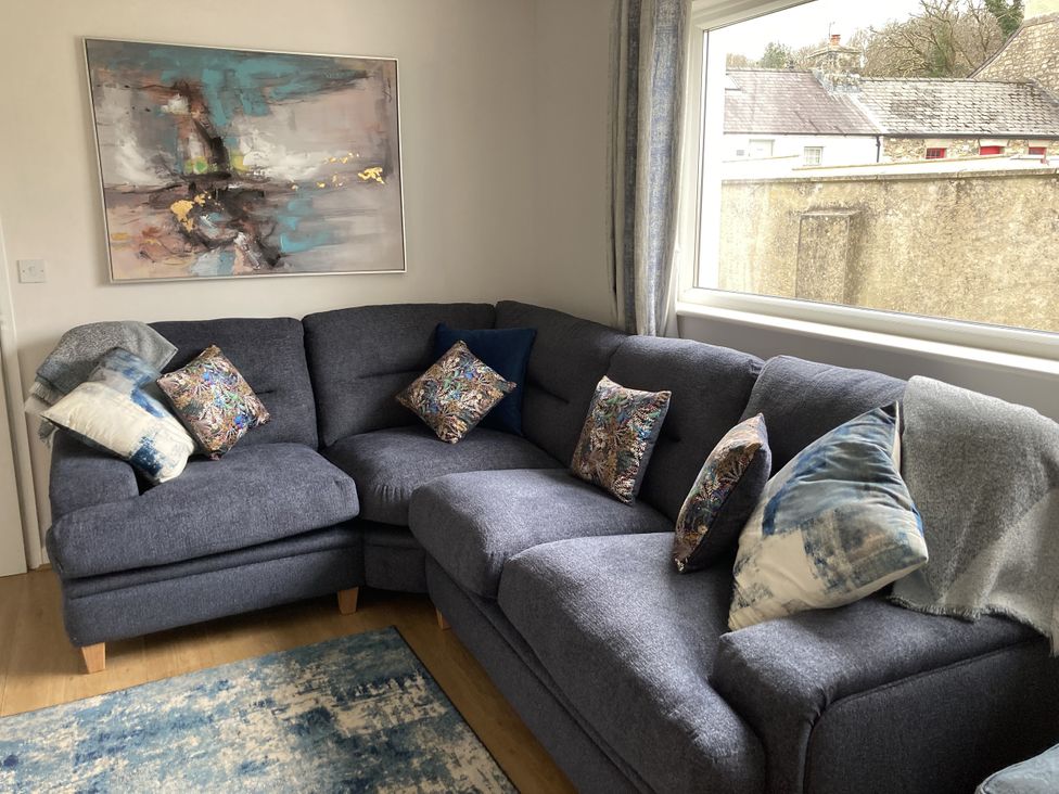 A living room with a sofa and cushions at Awel Deg, Newport