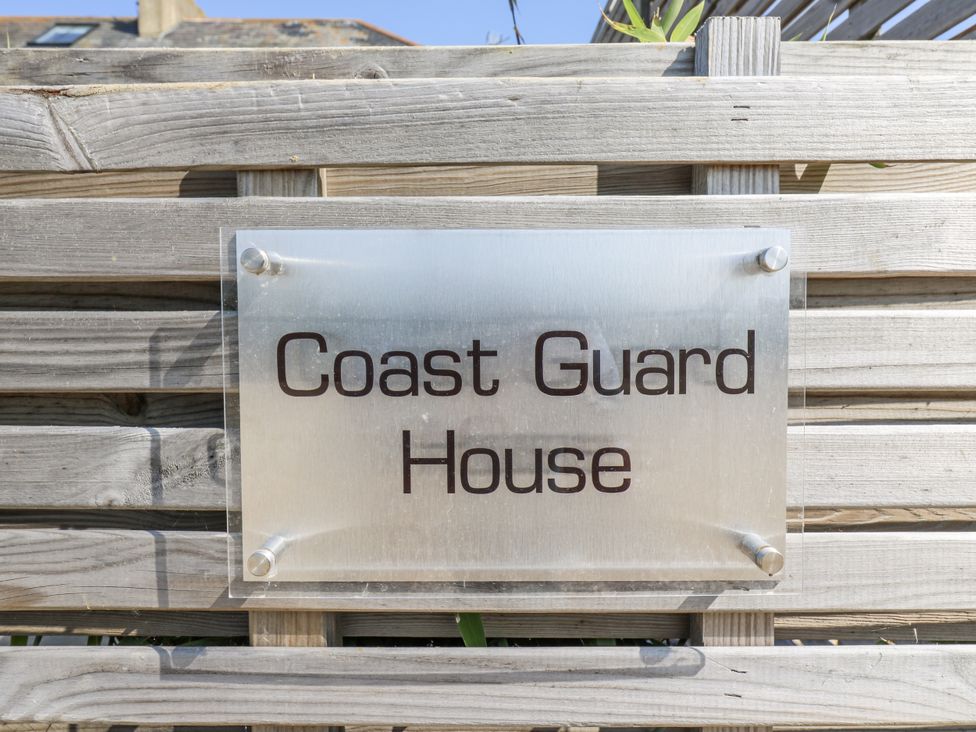 A sign on a wooden fence at Coast Guard House in Swalecliffe