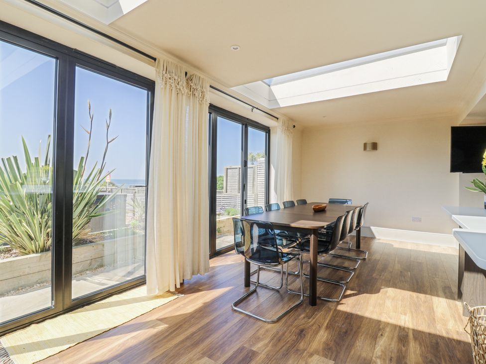 A dining room with a table and chairs at Coast Guard House in Swalecliffe