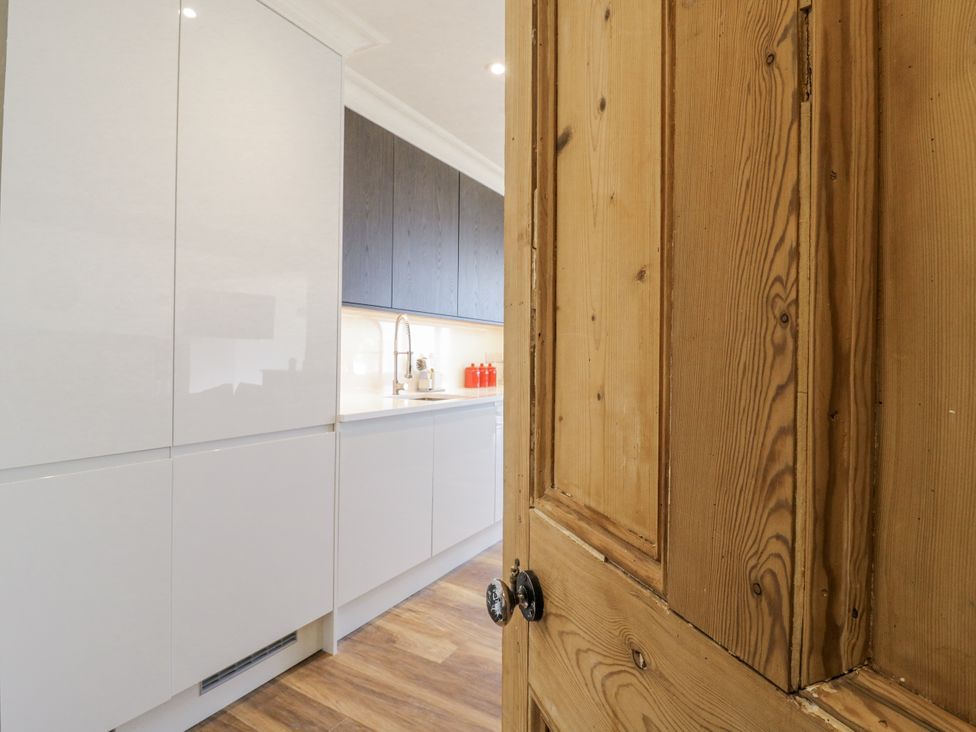 A kitchen with cabinets and a sink at Coast Guard House in Swalecliffe