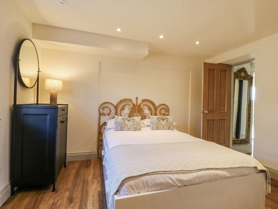 A bedroom with a bed and lamp at Coast Guard House Swalecliffe