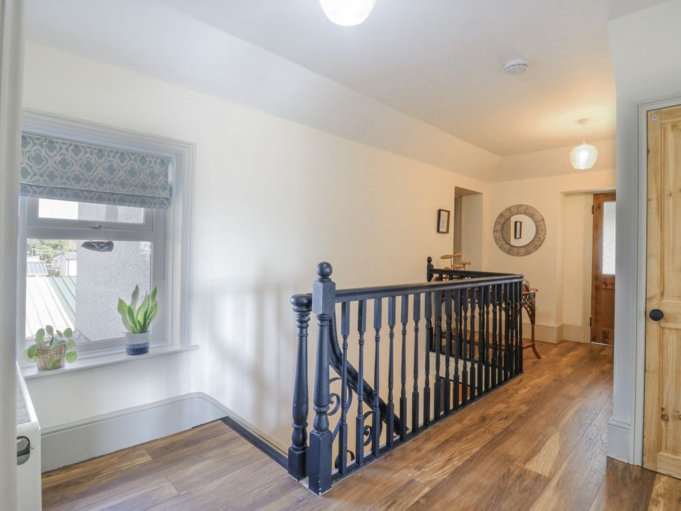 A hallway with a window and railings at Coast Guard House in Swalecliffe