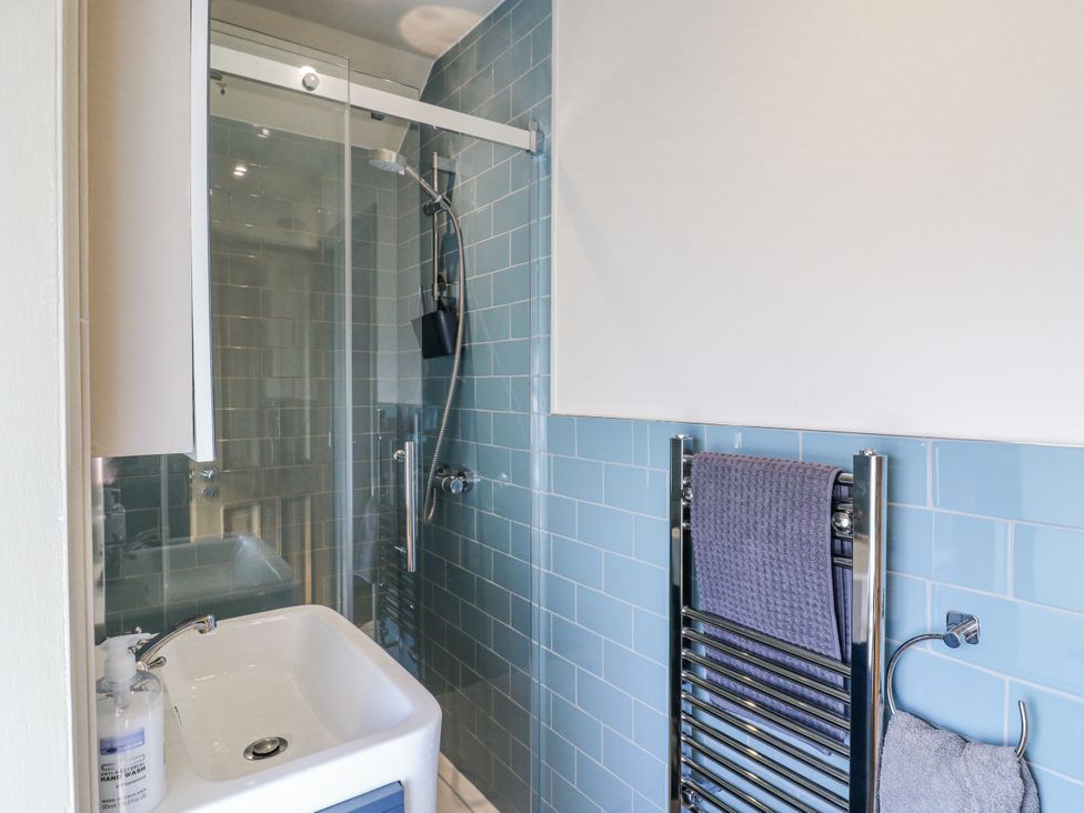 A bathroom featuring a shower and sink at Coast Guard House in Swalecliffe