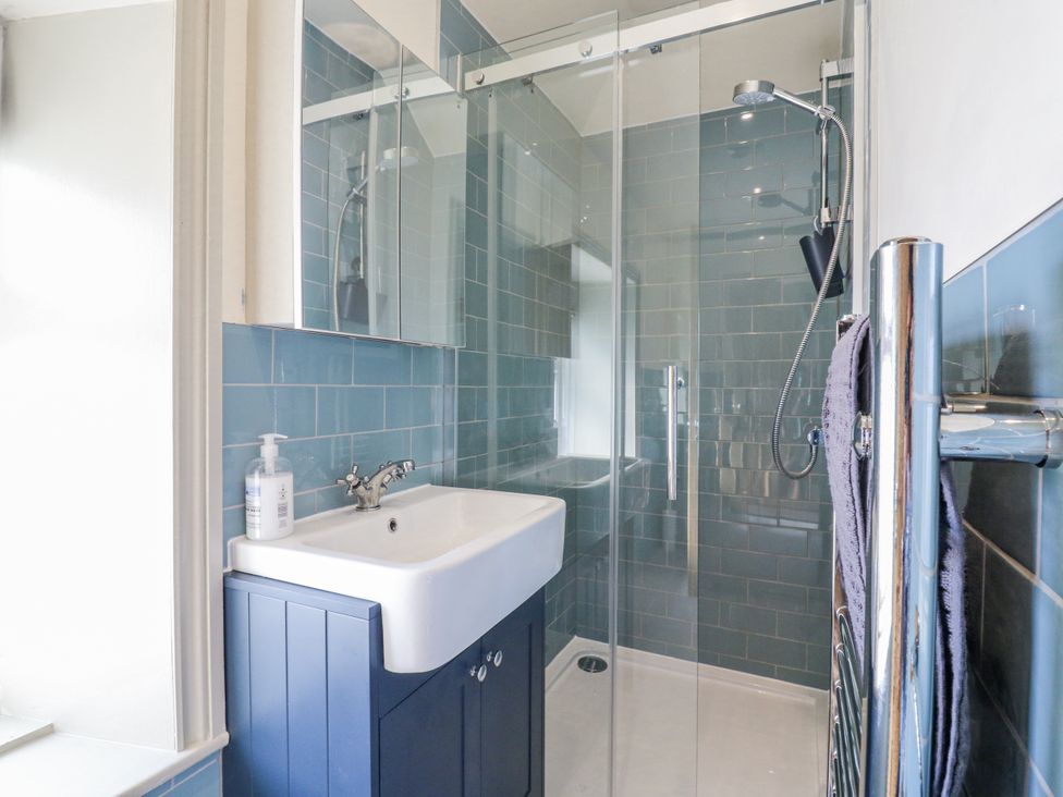 A bathroom with a shower and sink at Coast Guard House in Swalecliffe