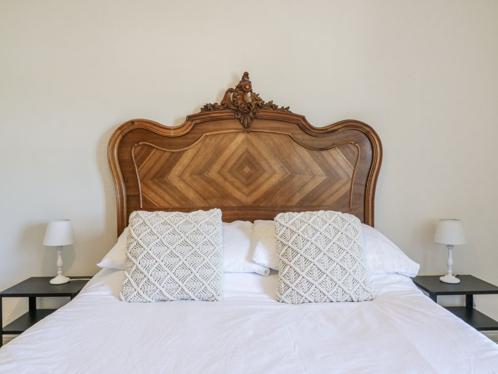 A bedroom with a bed and headboard at Coast Guard House Swalecliffe