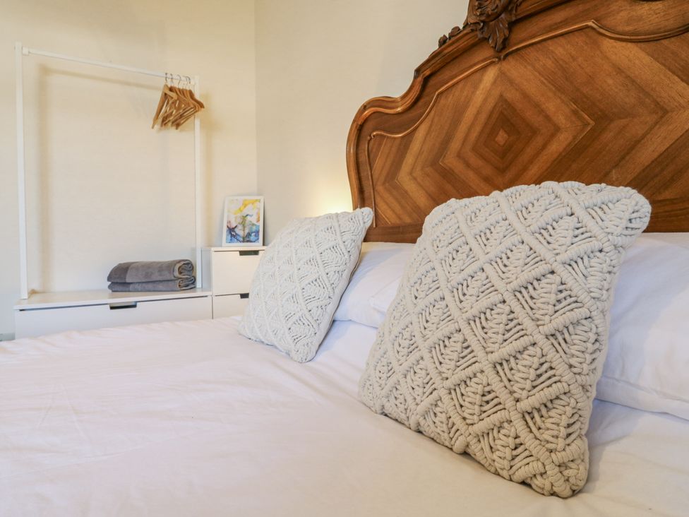A bedroom with a bed and decorative pillows at Coast Guard House in Swalecliffe