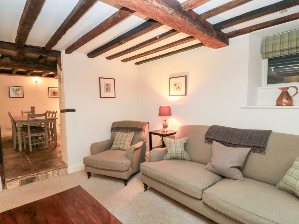 A living room with a sofa and armchair at Butlers Cottage in Burford