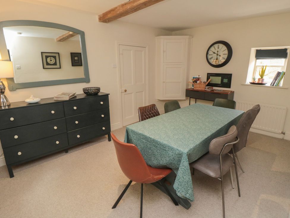 A dining room with a table and chairs at Black Horse Cottage in Swainby