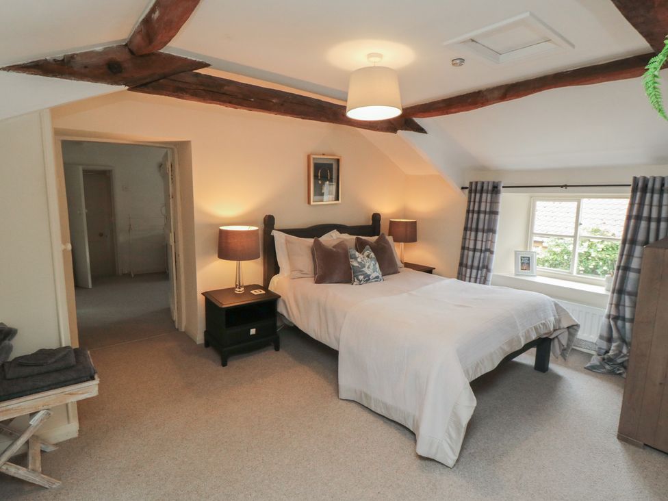 A bedroom featuring a bed and window at Black Horse Cottage Swainby