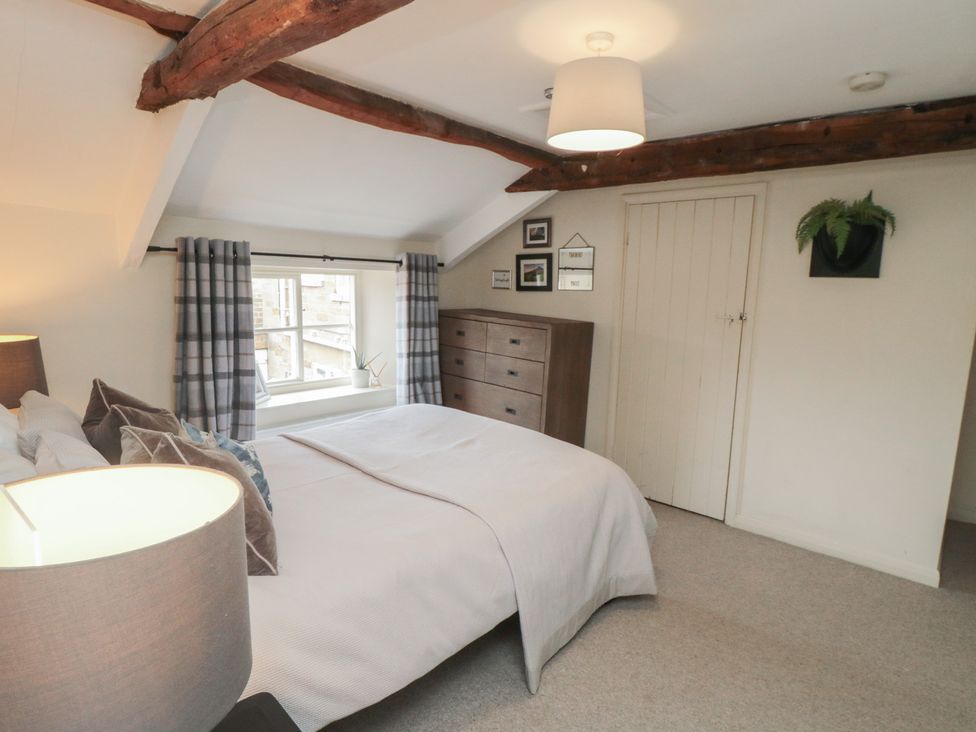 A bedroom with a bed and a dresser at Black Horse Cottage in Swainby