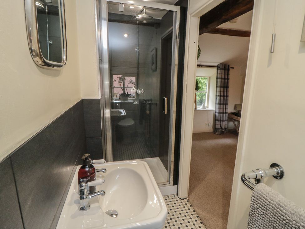 A bathroom featuring a sink and shower at Black Horse Cottage in Swainby