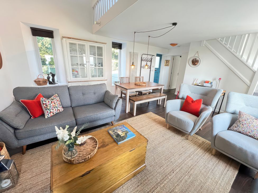 A living room with a sofa and dining table at Moorhurst Cottage Kents Bank near Grange-Over-Sands