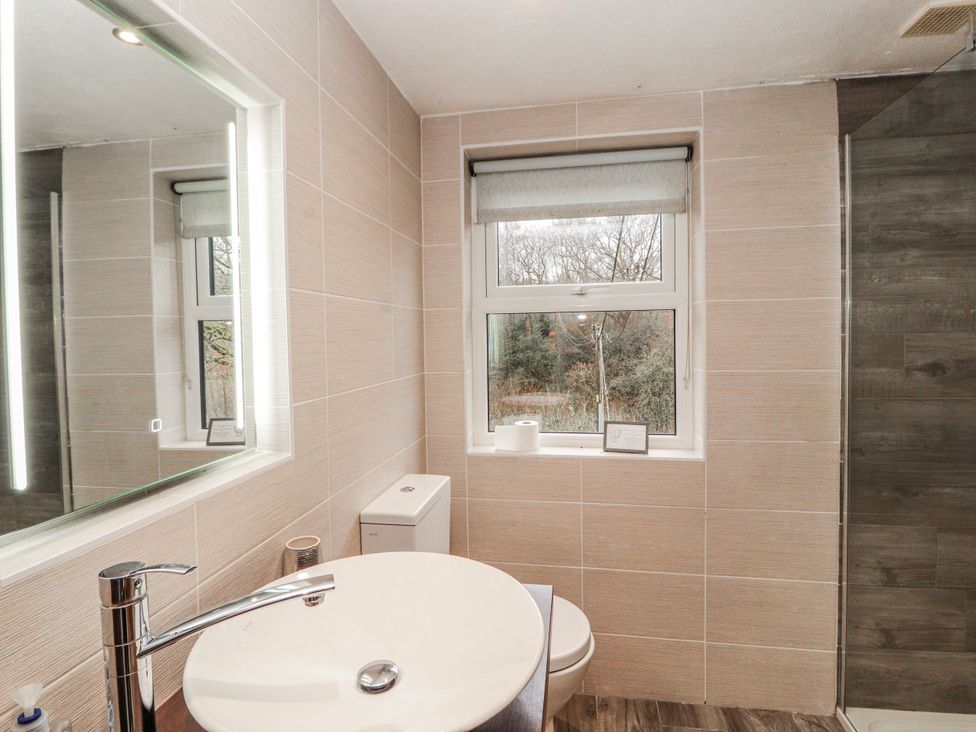 A bathroom with a sink, toilet, and shower at Greenbank Cottage Winster near Bowness-On-Windermere