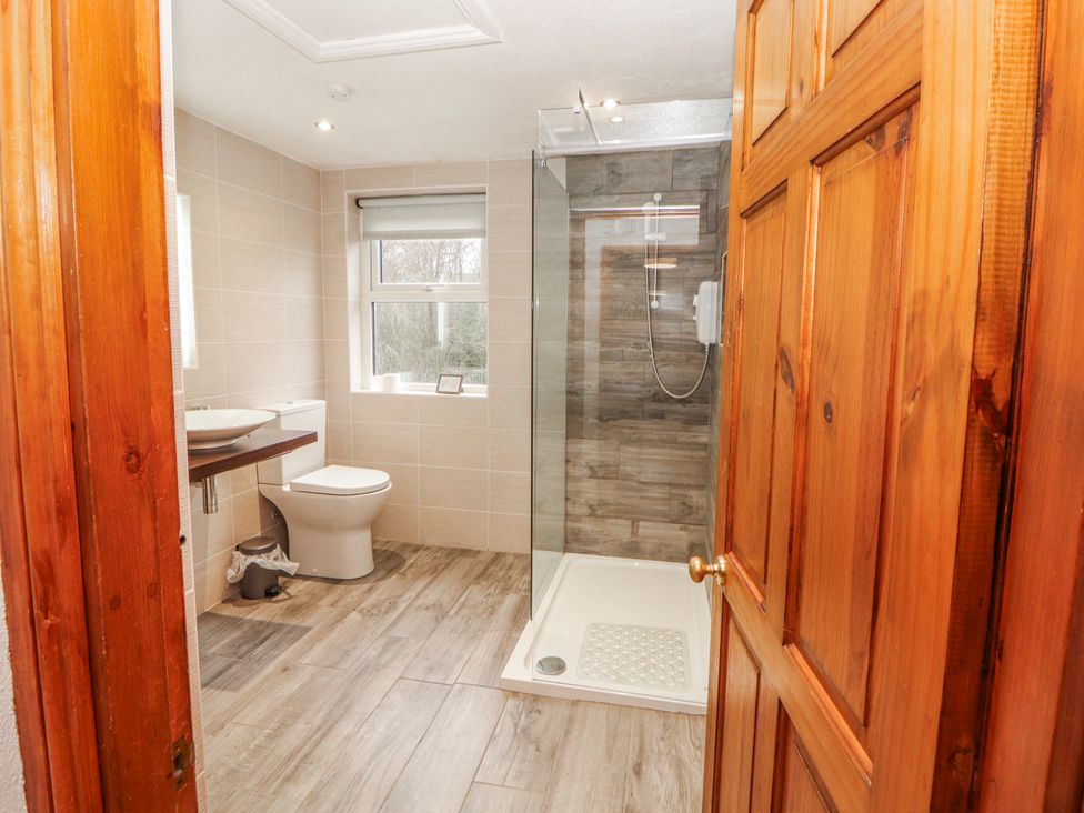 A bathroom with a shower and sink at Greenbank Cottage in Winster near Bowness-On-Windermere