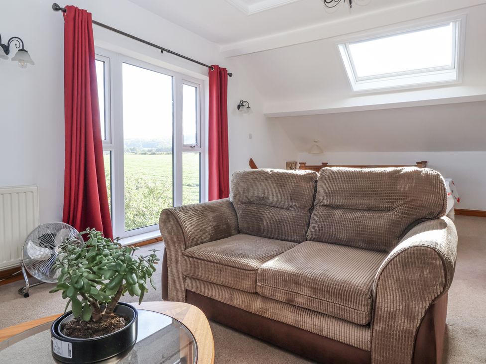 A living room with a sofa and plant at East Cottage near Rillington