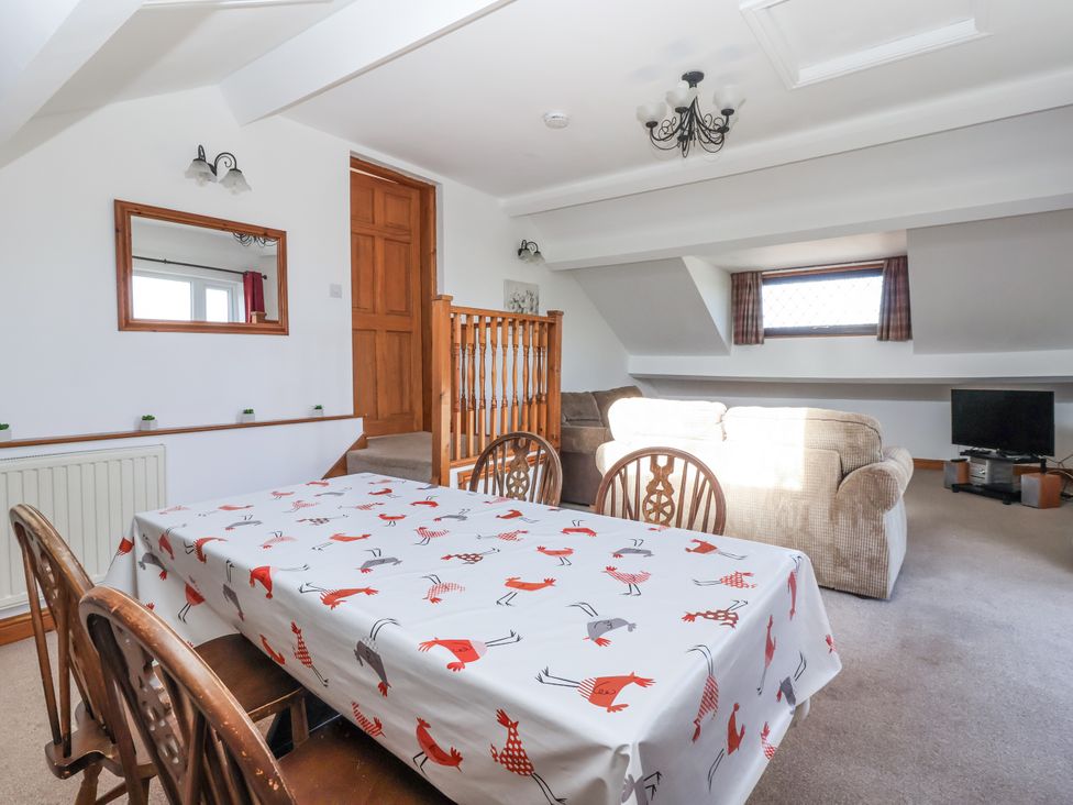 A dining room with a table and chairs at East Cottage in East Knapton near Rillington