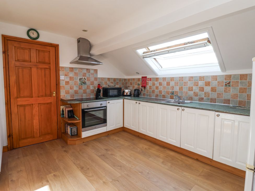 A kitchen with cabinets, stove, oven, and sink at East Cottage in East Knapton near Rillington