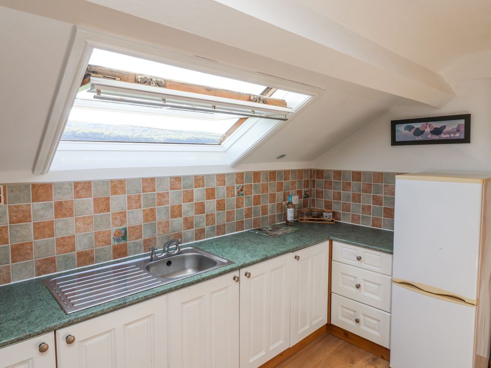 A kitchen with a sink and fridge at East Cottage near Rillington