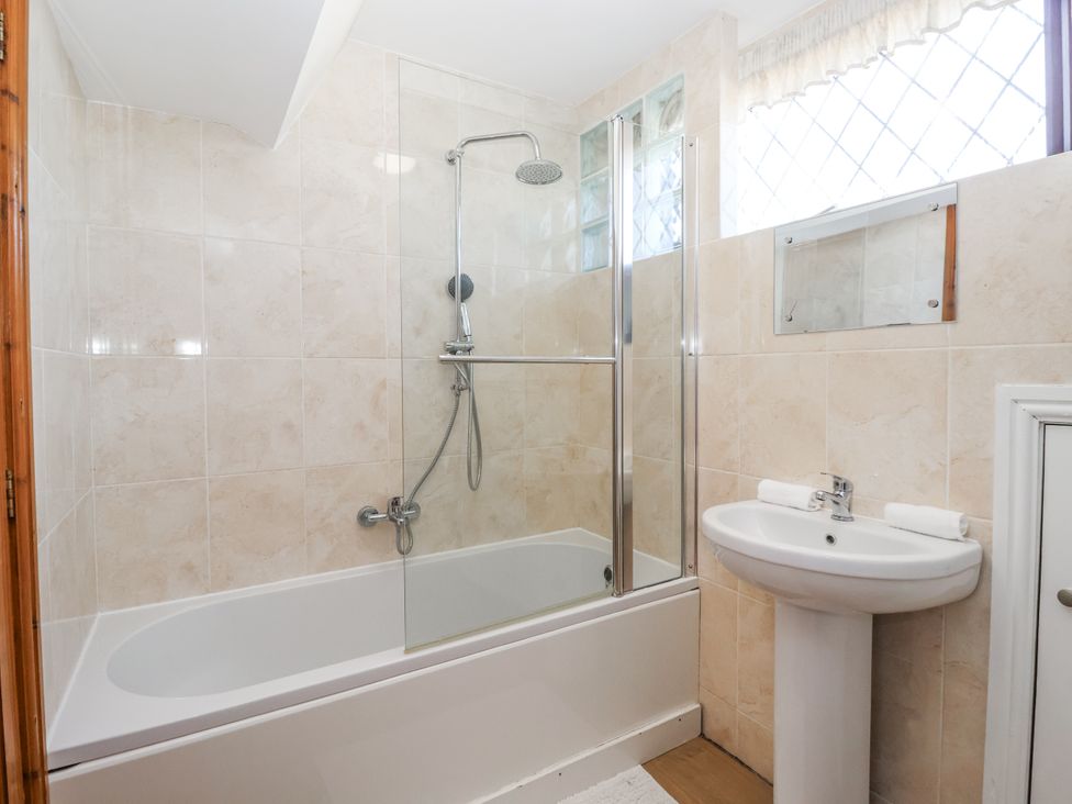 A bathroom with a bathtub and shower at East Cottage in East Knapton near Rillington