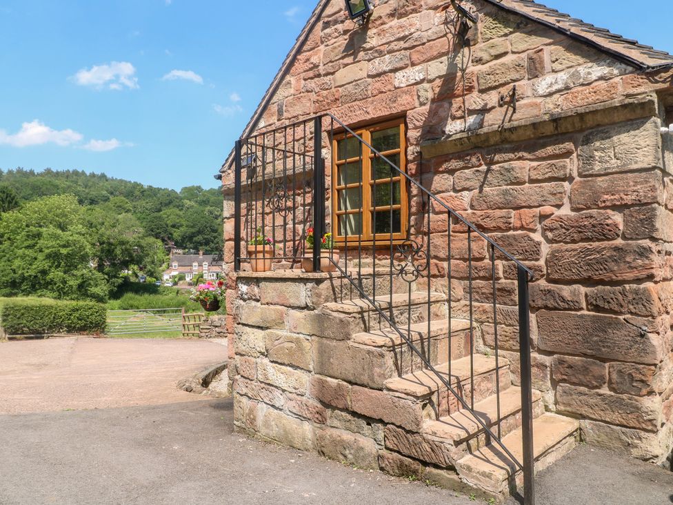 An exterior view of a building with stone walls and stairs at Bluebell Barn Stoke-on-Trent