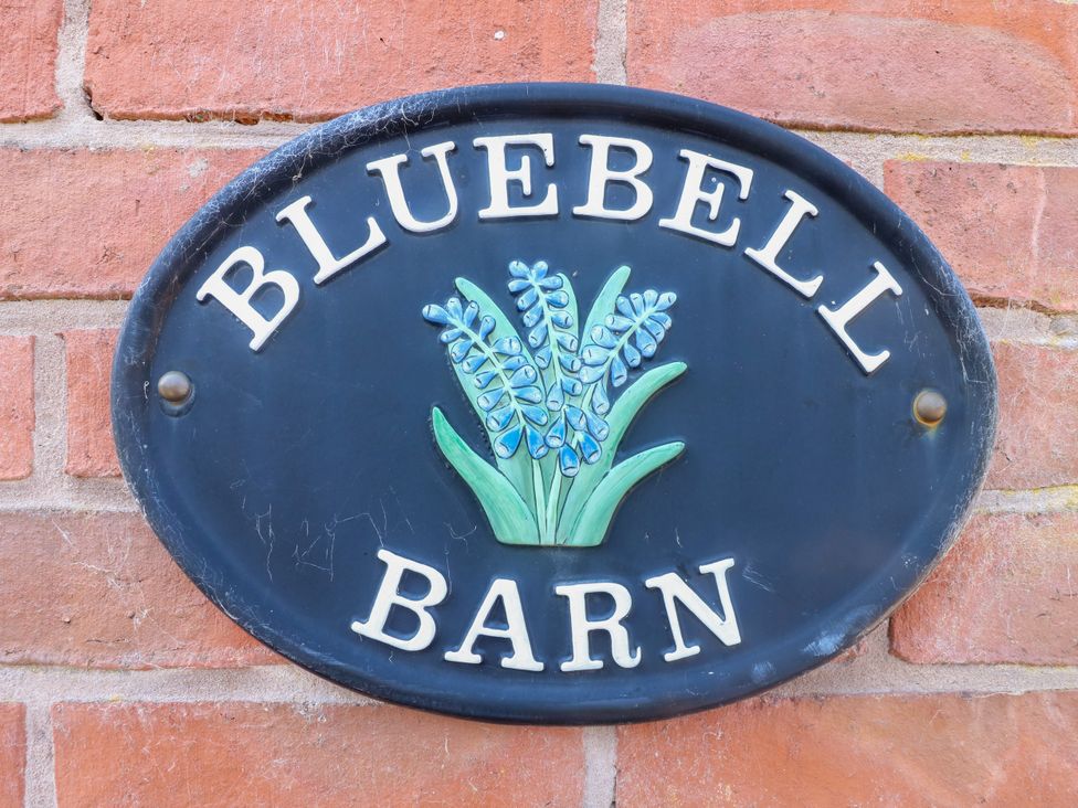 A sign displaying Bluebell Barn with a flower design at Bluebell Barn Stoke-on-Trent