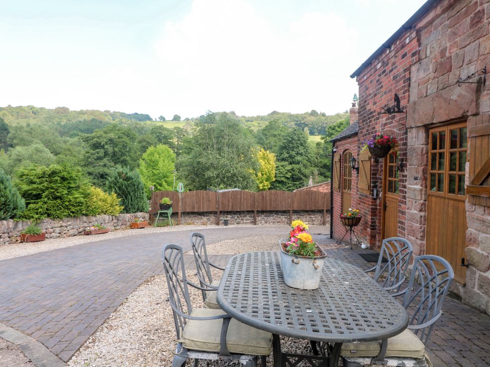 An outdoor area with a table and chairs at Bluebell Barn Stoke-on-Trent